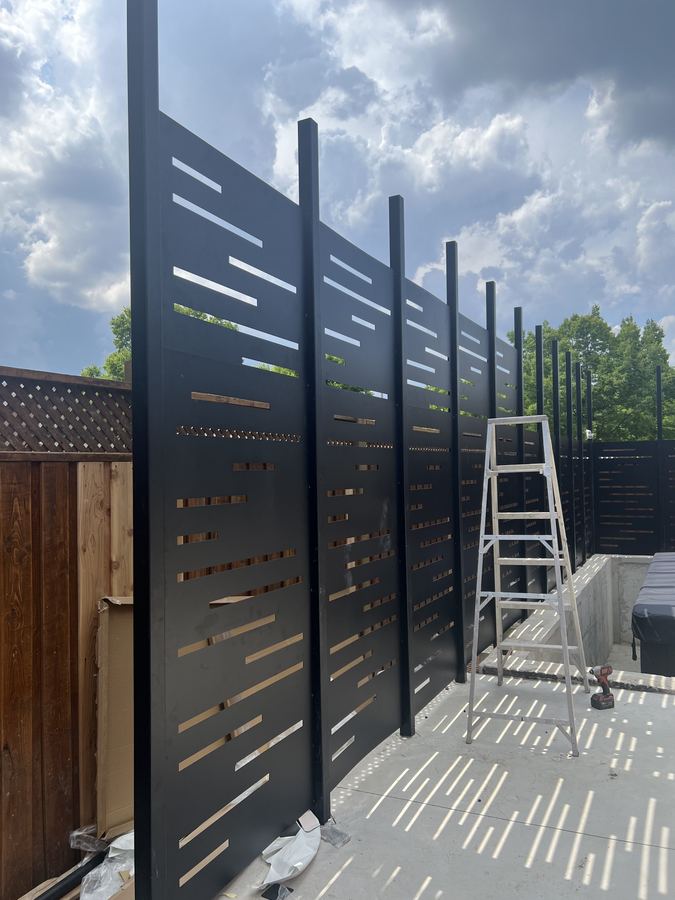 Aluminum privacy screen installed around hot tub area in Toronto backyard