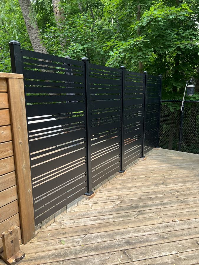 Privacy screen installed in Toronto townhouse backyard with second-storey balconies visible